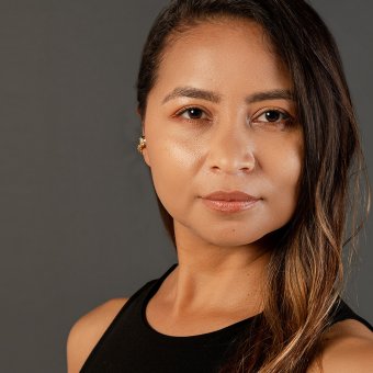 Profile photo of Jessica Parra. She looks towards the camera. Her expression is serious, with a slight smile. She has brown hair and brown eyes. The background of the photo is completely grey.