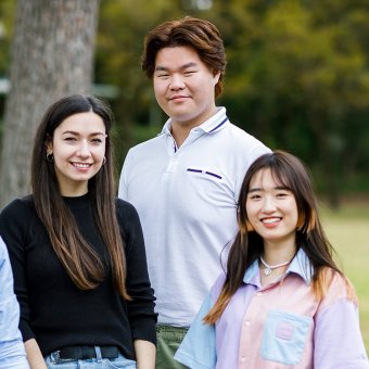 Four TAFE students on green campus grounds