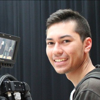 Student using professional video camera equipment