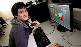 person in front of computer with 3D modelling