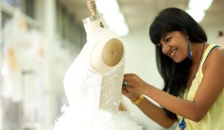 Person working on dress on fitting mannequin