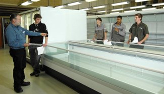 Students and teacher around glass tank of water
