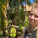 TIWA student Kersti, posing on TAFE campus grounds near a palm tree