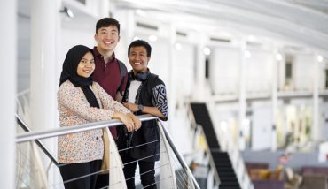 Three students at top of stairs