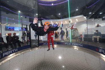 Student participating in indoor skydiving