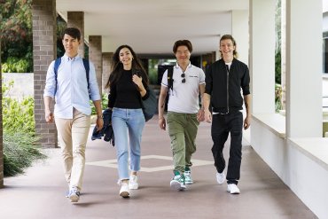 Group of four students walking along path at TAFE Bentley campus