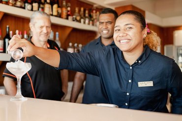 Person serving drink at hospitality venue in Broome